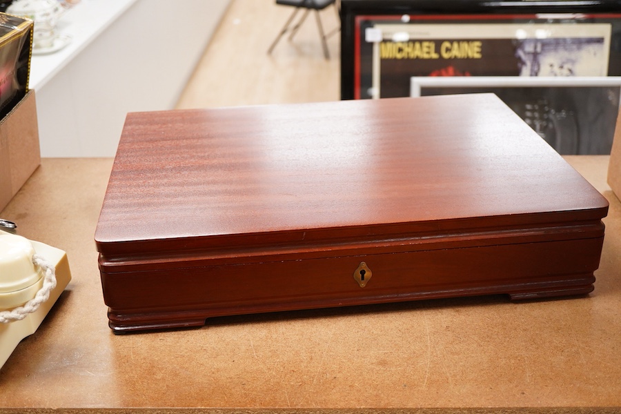 An Elizabeth II canteen of silver cutlery for eight, by Mappin & Webb, comprising table and dessert forks, dessert, soup and teaspoons, silver handled steel table and dessert knives two table or serving spoons and a pair